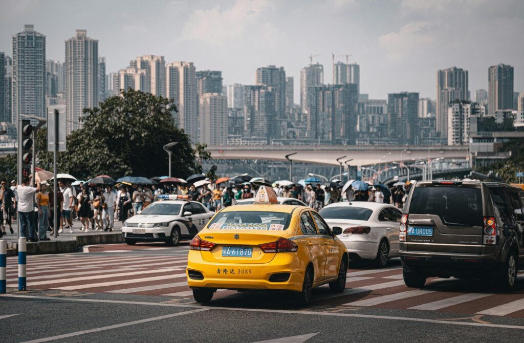 pexels-photo-11826998-11826998 Busy street in Chongqing, China with taxis and modern skyscrapers in the background.