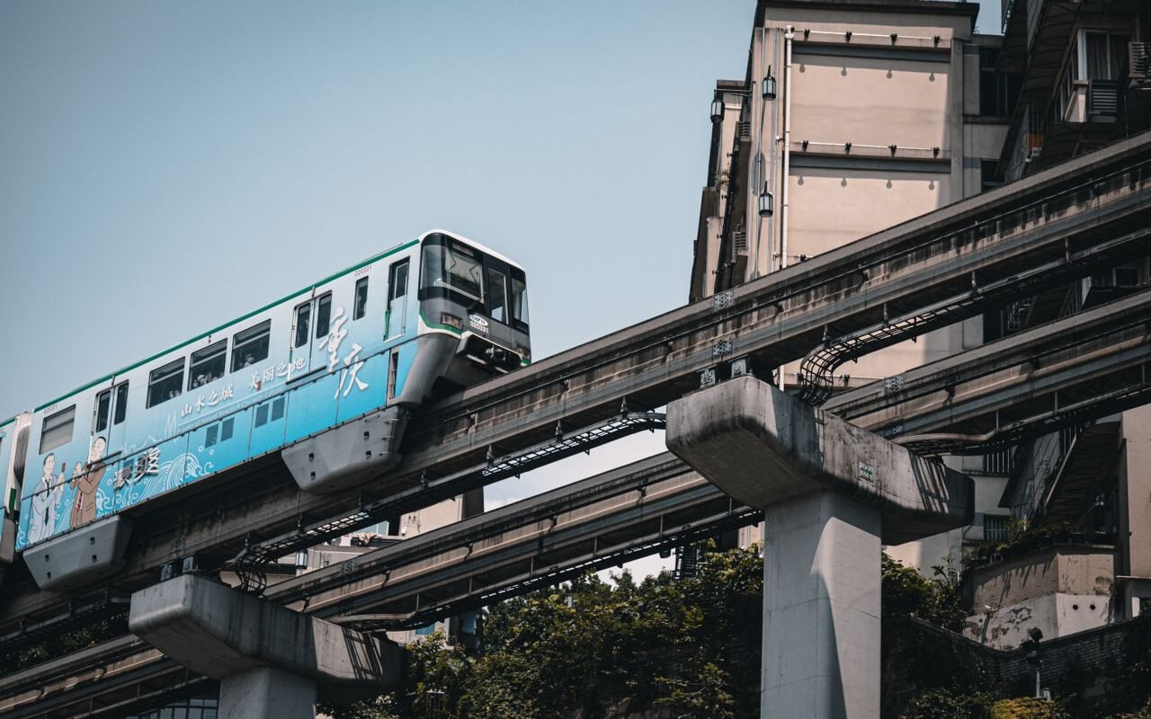 Chongqing's iconic monorail traversing urban architecture, capturing dynamic urban transport.