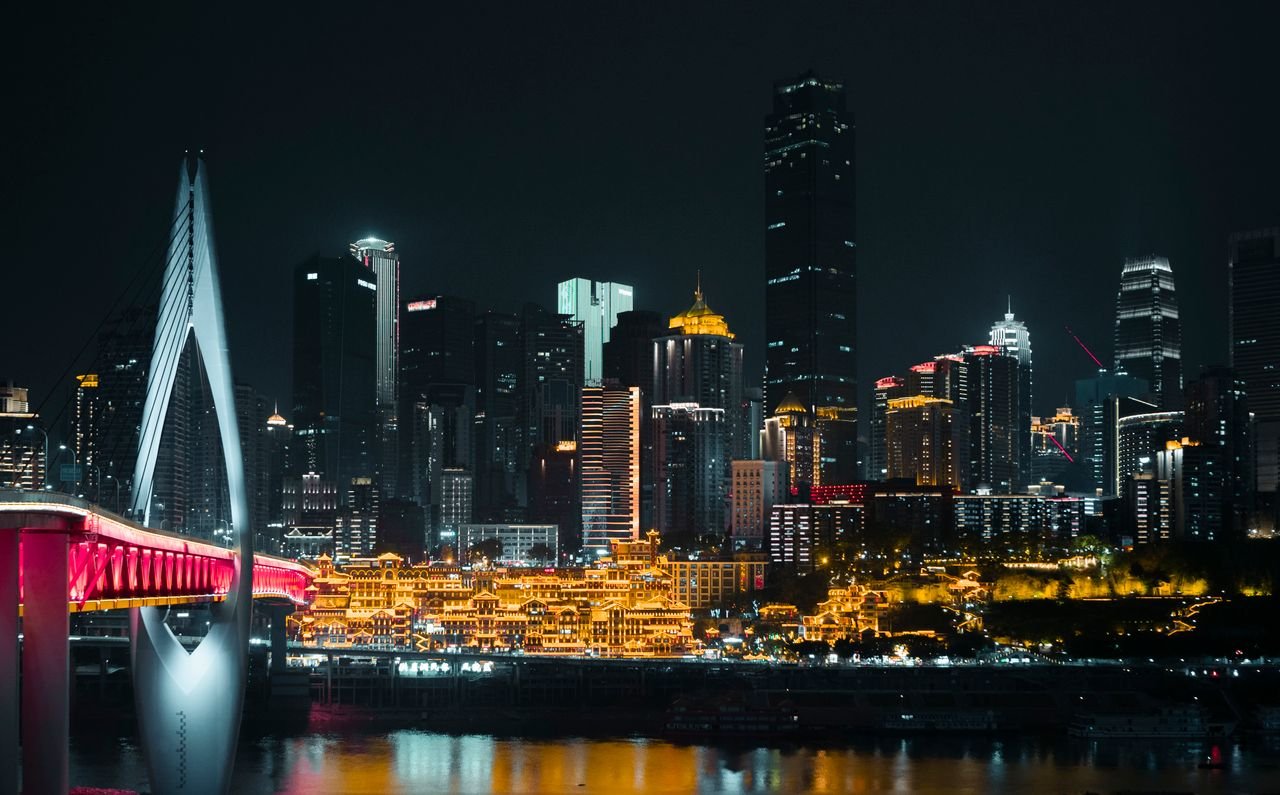 Explore the illuminated skyline of Chongqing featuring modern skyscrapers and vibrant city lights.